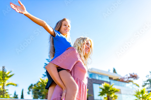 blonde mom and her cute child in summer beach seaside in tropics