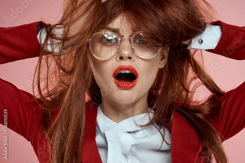 Elegant woman wearing glasses red lips jacket long hair pink
