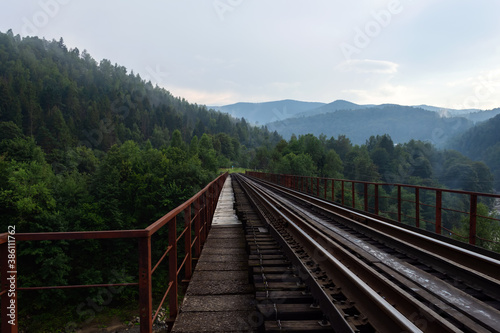 Railway bridge among beautiful mountains. Travels. Transport. © vallerato
