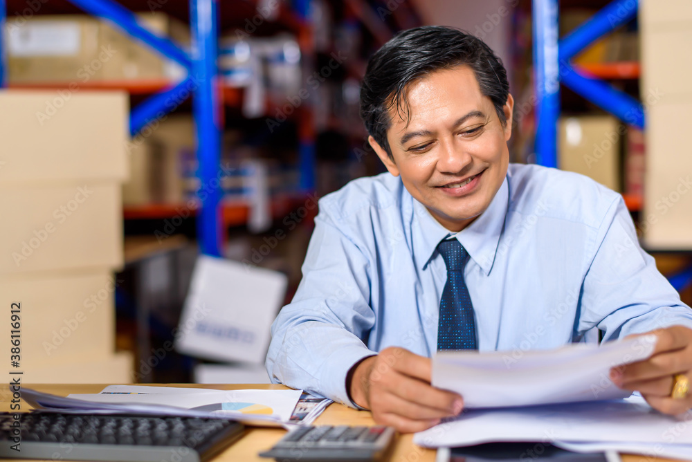 businessman checking report at cargo with goods or merchandise warehouse and check control loading from Cargo freight ship for import and export. Teamwork successful concept.