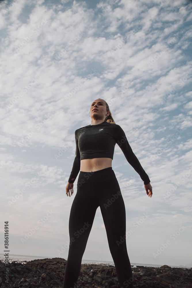 fitness shot of fit young woman with sky in background fitness shot of fit young woman with sky in background