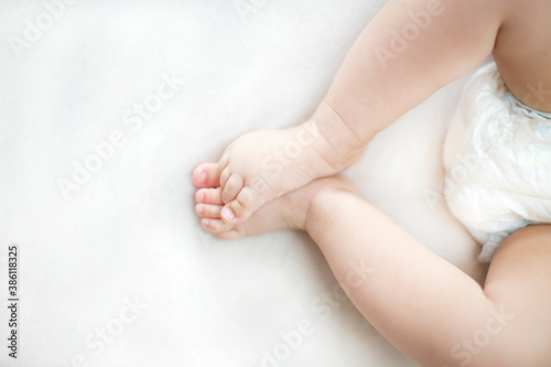 Small baby girl feet on the bed