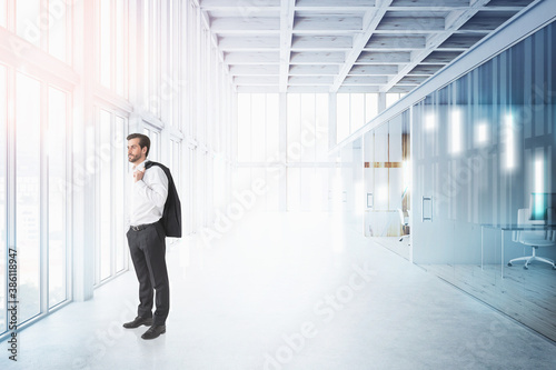 Businessman in panoramic office, financial graph
