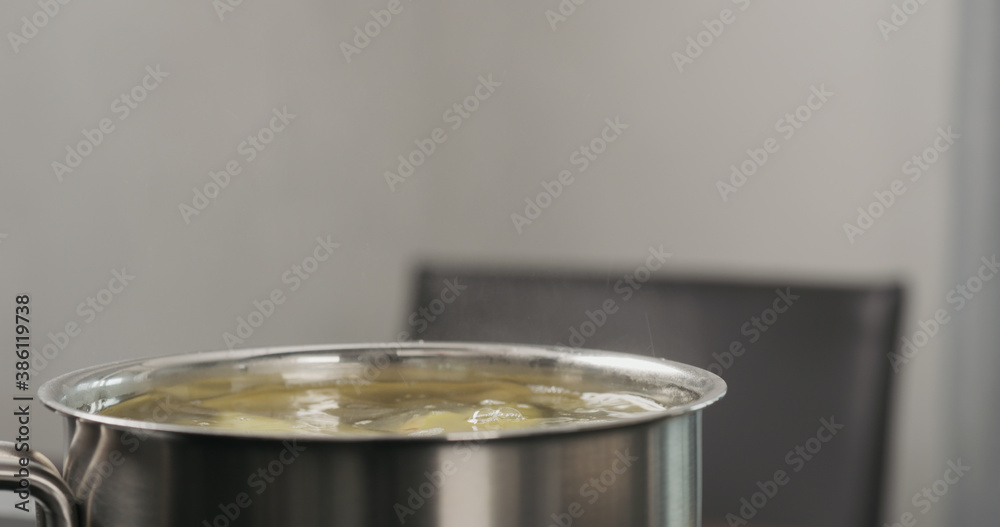 potato wedges boiling in saucepan potato wedges boiling in saucepan