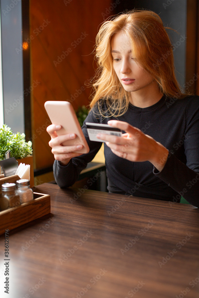 Woman making card payment through mobile phone to pay bills. Vertical photo. Woman making card payment through mobile phone to pay bills. Vertical photo.