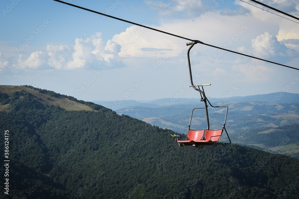 Empty chairlift on a background of beautiful autumn mountains