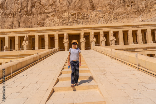 A young woman on the entrance stairs to the Funerary Temple of Hatshepsut in Luxor. Egypt