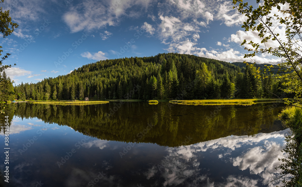 reflection from sky and forest in a clear mountain lake reflection from sky and forest in a clear mountain lake