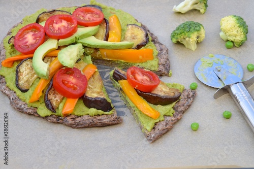 Broccoli pizza with mashed pea, eggplant, yellow bell pepper, avocado and tomato