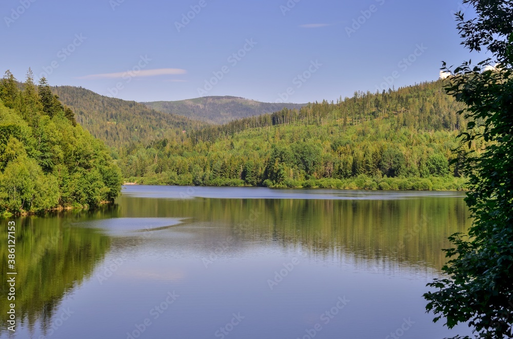 Beautiful mountain landscape. Lake and green trees between the hills.