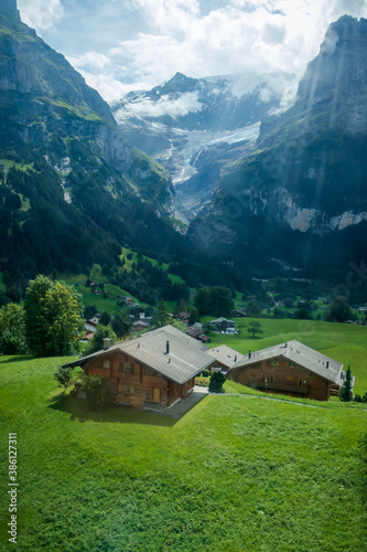 Houses in a valley on a summer day in the Valais Alps of Switzerland. 