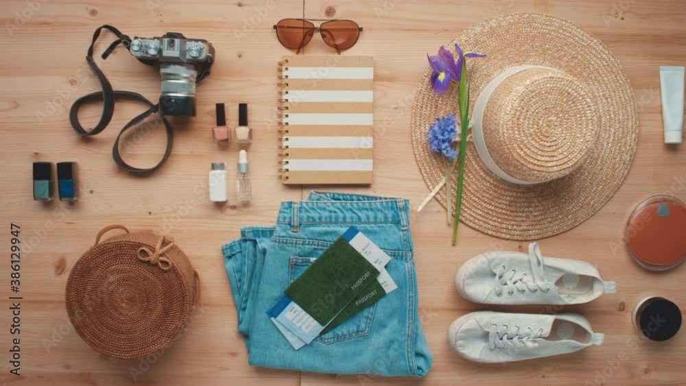 Horizontal from above flat lay shot of travel objects for baggage including clothes, cosmetics and international passports with tickets