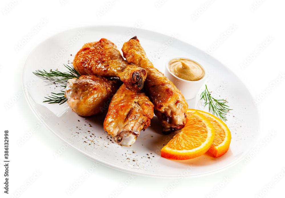 Barbecue chicken drumsticks with vegetables on white background
Barbecue chicken drumsticks with vegetables on white background