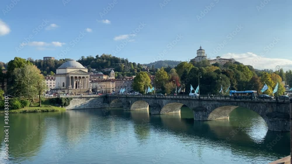 City life of Turin Piedmont Italy, with bridge, Great Mother church surrounded by trees and hills. Far on the hill the Cappuccini's church. City life of Turin Piedmont Italy, with bridge, Great Mother church surrounded by trees and hills. Far on the hill the Cappuccini's church.