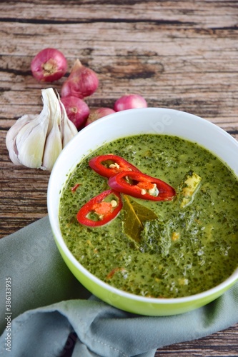 Daun ubi tumbuk or daun singkong or pounded and seasoned cassava leaves. Traditional Indonesian cuisine photo