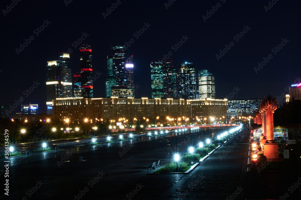 Naklejka premium Space landscape of a night city, sparkling with lights and skyscrapers in the background. Russian city landscape.