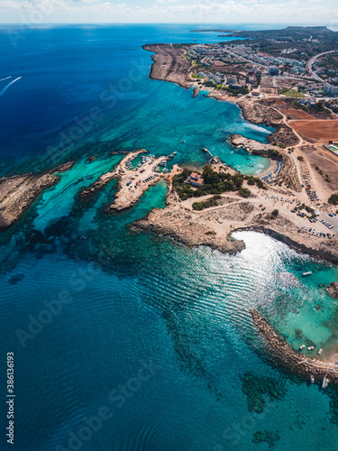 Beautiful aerial view over Protaras beaches with crystal clear turquoise water and sandy beach. Perfect summer vacation in Protaras, Cyprus. 