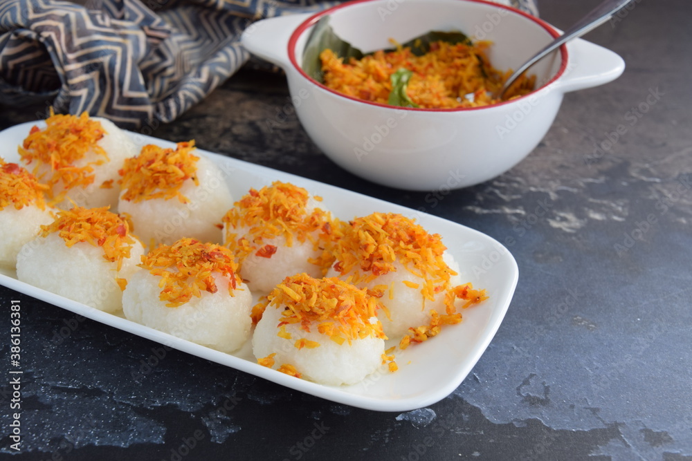 Ketan Serundeng. Indonesian cuisine. Savory steamed cake of glutinous rice with coconut milk, topped with spicy roasted desiccated coconut Ketan Serundeng. Indonesian cuisine. Savory steamed cake of glutinous rice with coconut milk, topped with spicy roasted desiccated coconut