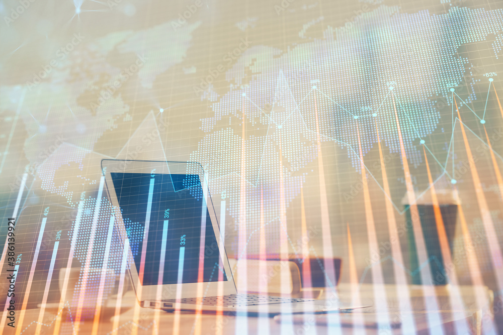Stock market chart hologram drawn on personal computer background. Multi exposure. Concept of investment. Stock market chart hologram drawn on personal computer background. Multi exposure. Concept of investment.
