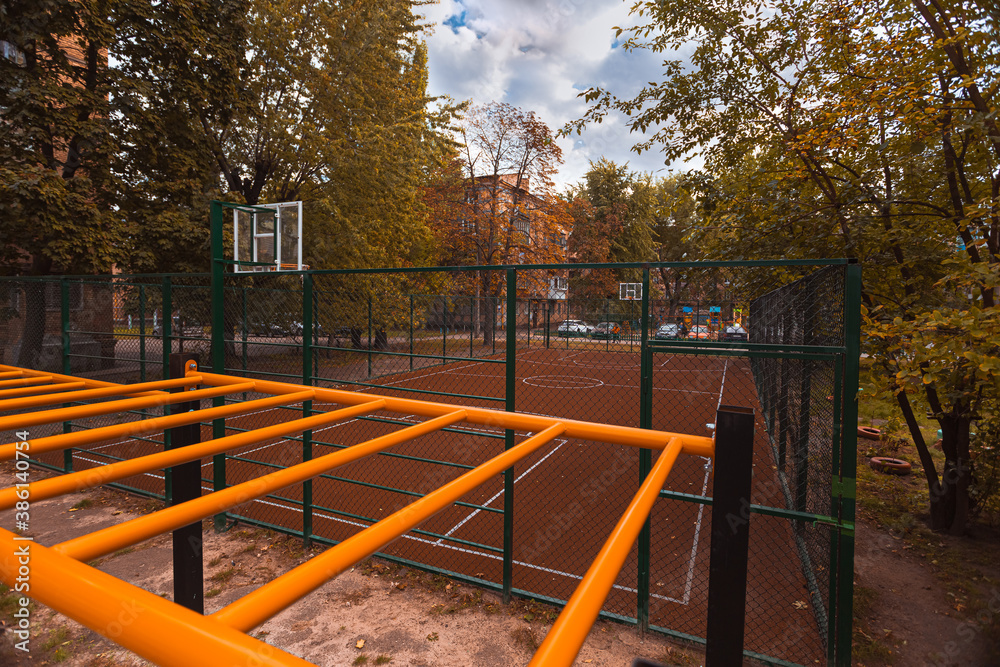 Basketball court in the courtyard in a poor neighborhood, autumn time, copy space Basketball court in the courtyard in a poor neighborhood, autumn time, copy space
