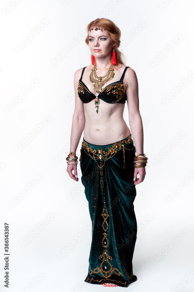 beautiful woman in green belly dance costume standing and looking away on white background beautiful woman in green belly dance costume standing and looking away on white background