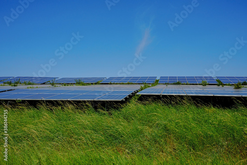 solar panels on a green hill
