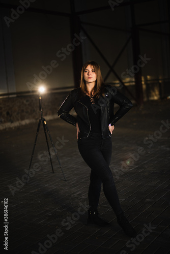 Girl in a leather jacket on an old abandoned construction site © prokop.photo