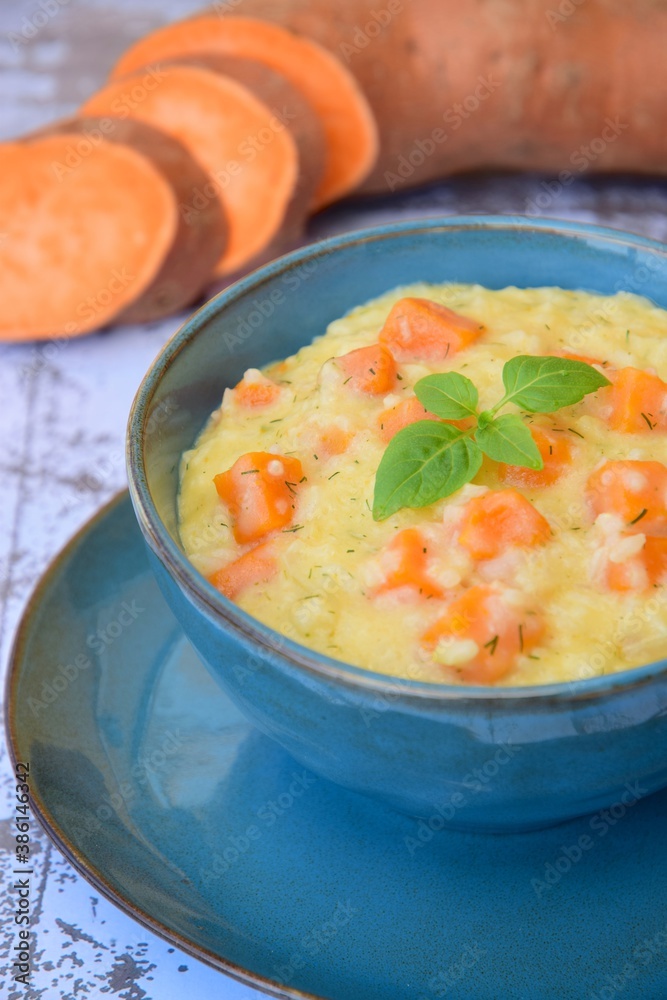 Sweet potato risotto with basil leaf in a bowl Sweet potato risotto with basil leaf in a bowl