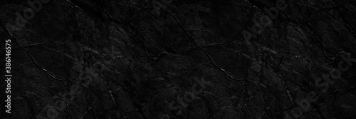Rock texture. Stone background. Black abstract background. Grunge. Veins and cracks on the rock surface.