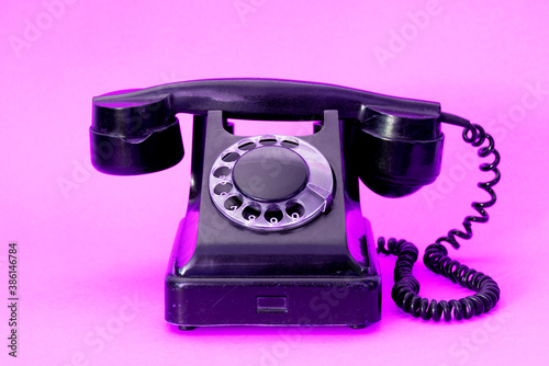A vintage dial phone from the 80s in abstract vivid colors.  Retro style landline telephone art.