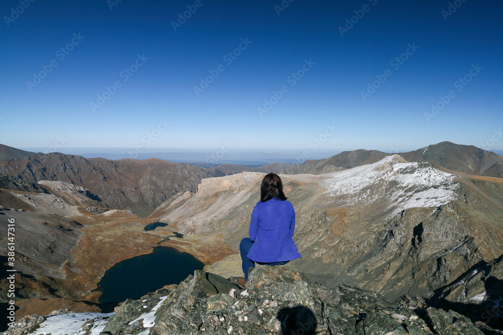 A tourist admires the view of the mountain ranges of Arkhyz, Russia.