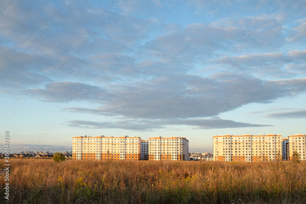 Landscape view to new residential houses against sunset sky