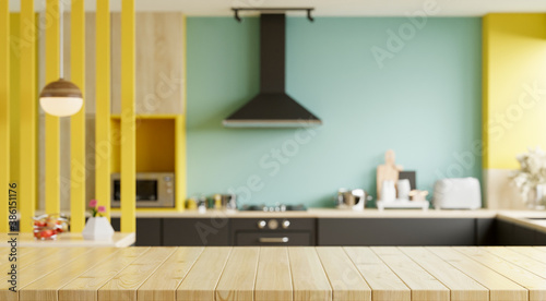 Empty wooden table and blurred kitchen yellow wall background/Wood table top on blur kitchen counter.