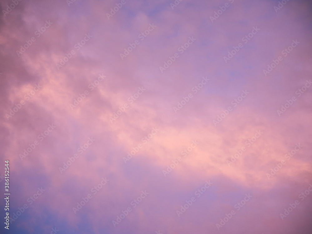 Multicolored clouds during sunset. Clouds, purple, hazy, blue and violet sky, hints of yellow Multicolored clouds during sunset. Clouds, purple, hazy, blue and violet sky, hints of yellow