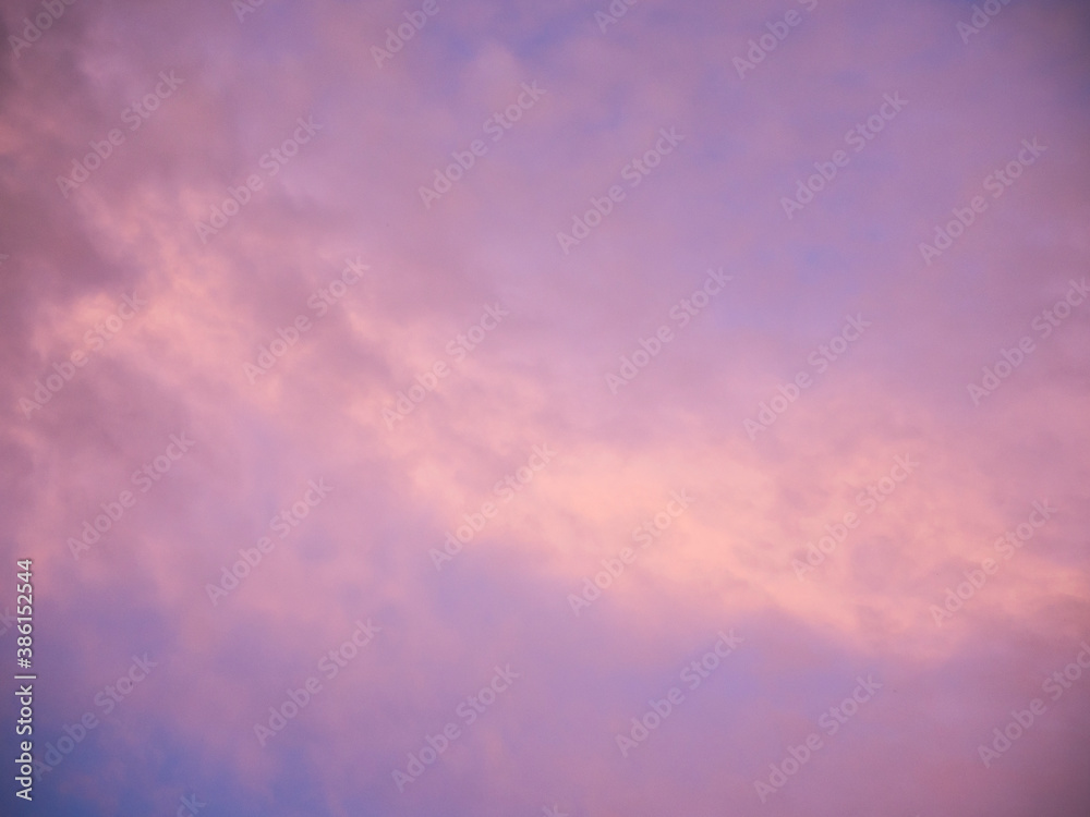 Multicolored clouds during sunset. Clouds, purple, hazy, blue and violet sky, hints of yellow