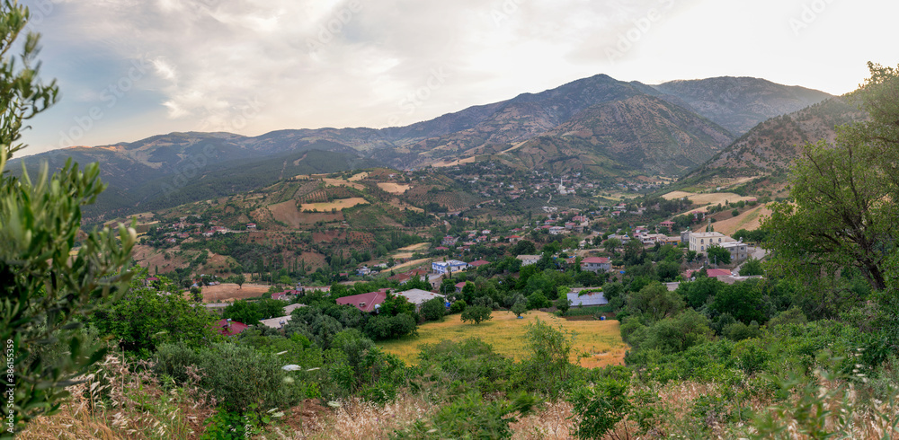 a village among the mountains and greenery