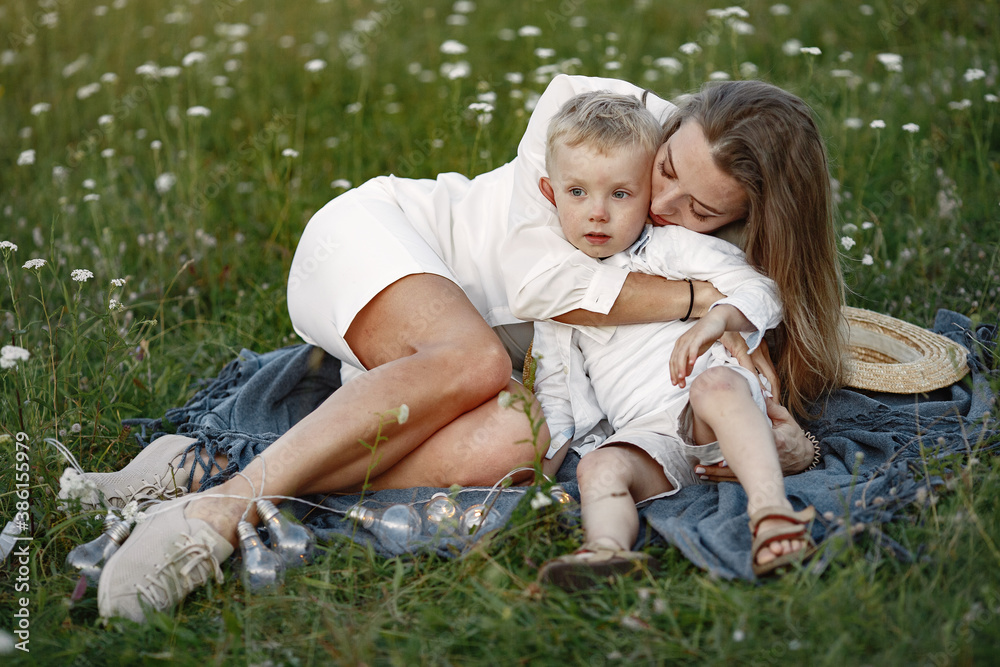 Family spends time on vacation in the village. Child playing in nature. People walk in the fresh air. Family spends time on vacation in the village. Child playing in nature. People walk in the fresh air.