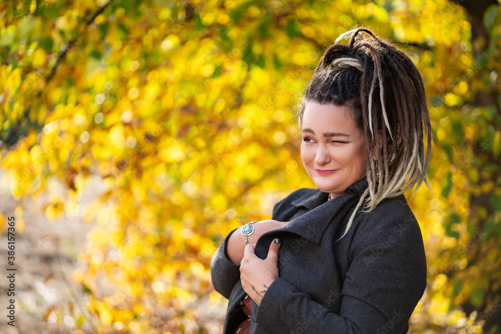 Young happy woman with dreadlocks outdoors in autumn Young happy woman with dreadlocks outdoors in autumn