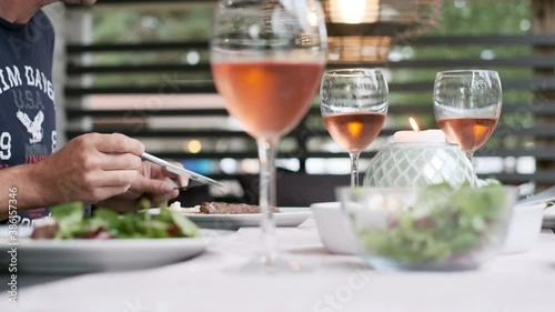 People having cosy summertime dinner photo