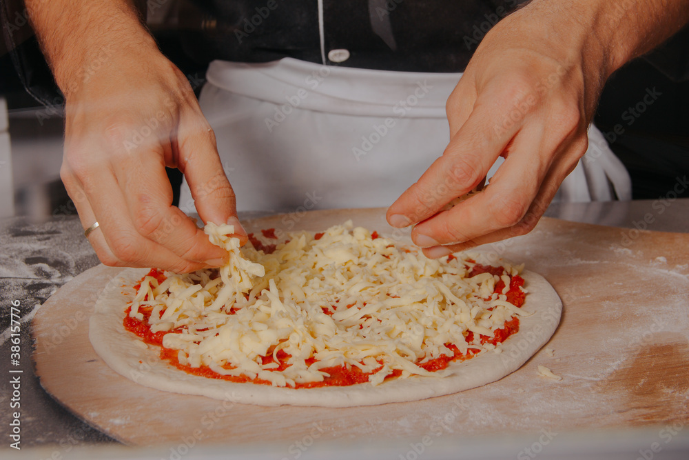 preparing artisan pizza in Italian style pizzeria
