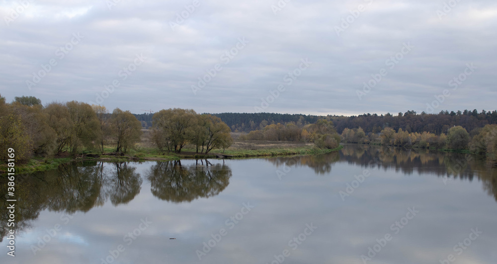 Late autumn. River in the Park on an autumn day, the water looks brownish-yellow, Late autumn. River in the Park on an autumn day, the water looks brownish-yellow,