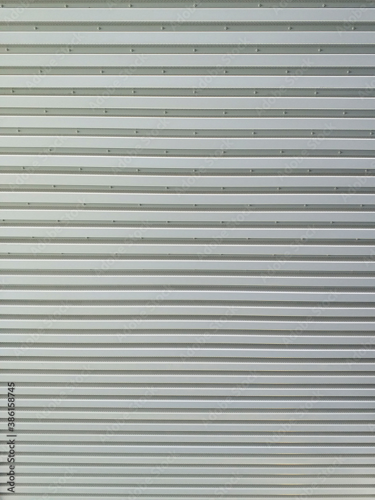 Metallic roll up door. Old Steel rolling shutter background. Metal security shutters. Abstract wire frame background. Galvanized steel wall plate Metallic roll up door. Old Steel rolling shutter background. Metal security shutters. Abstract wire frame background. Galvanized steel wall plate