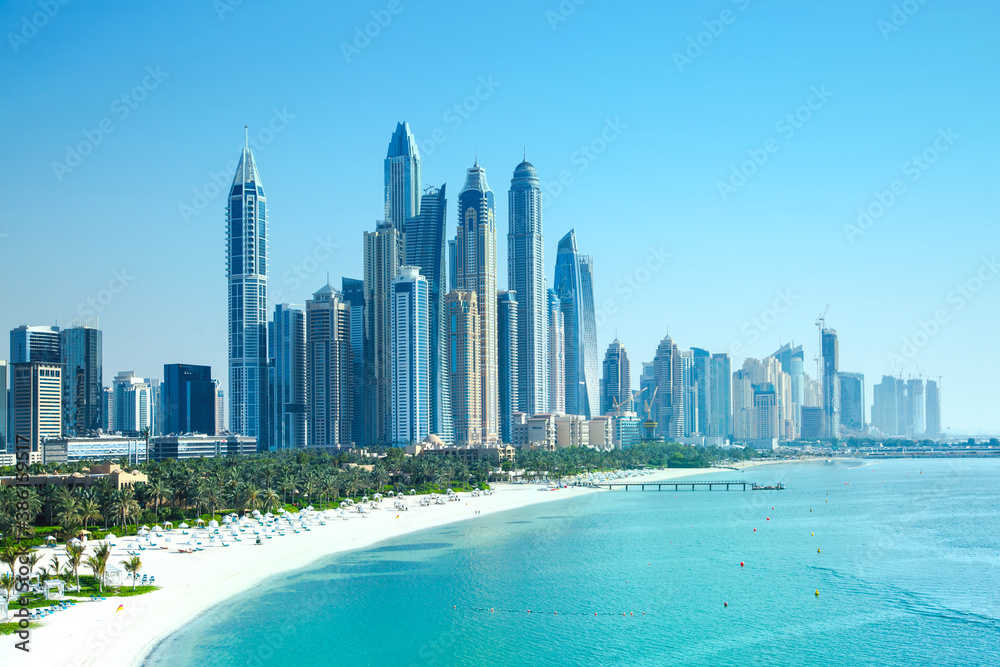 Obraz premium UAE United Arabs Emirates. Dubai marina skyscrapers from from Persian gulf beach line. View at apartment buildings, hotels and offices, modern residential development of UAE