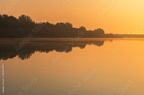 The Kura river flowing through the city of Neftechala at sunrise © alexmu