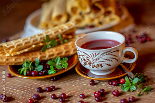 Cup of tea with vitamin C cranberries and waffles