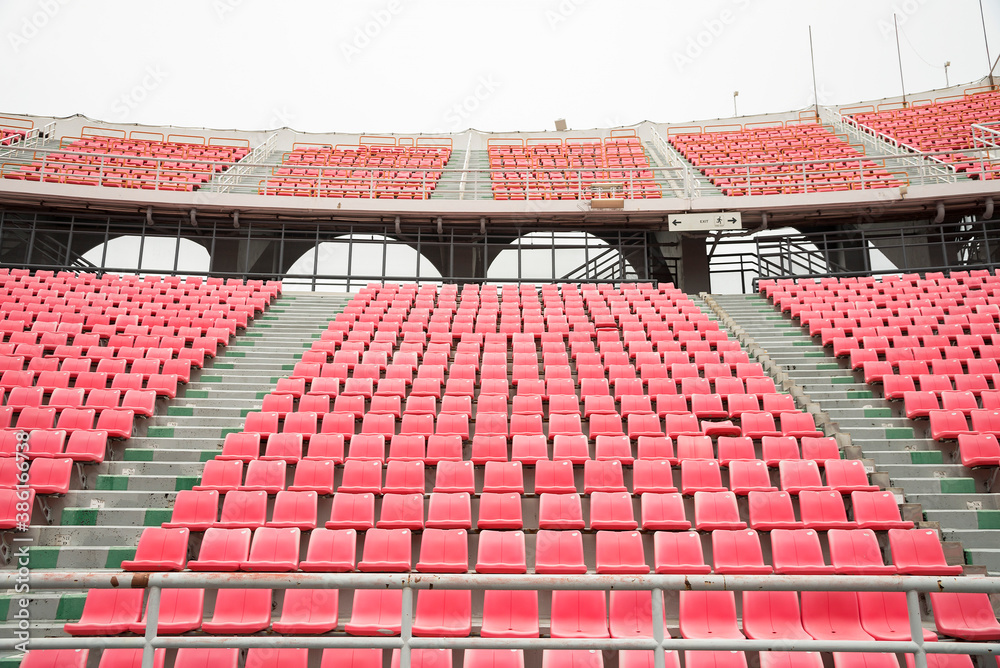 Fototapeta premium Pink spectator seats in a sports stadium.