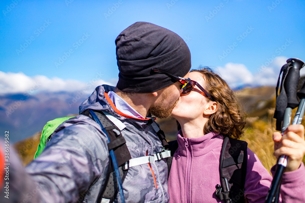 newwed couple hikers trekking in mountains in wedding honey moon