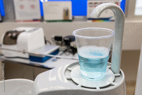 Mouth rinse in cup at dental clinic. Rinse before treatment.