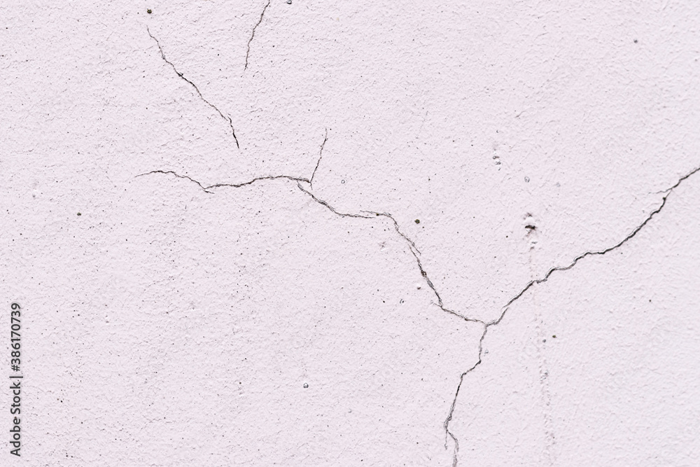 Obraz premium Light textured plaster as a background.Cracks in the wall