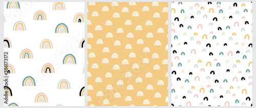 Simple Scandinavian Style Seamless Vector Patterns with Rainbows and Arc. Lovely Nursery Art with Pastel Color Doodles Isolated on a White and Yellow Background. Funny Infantile Style Print.
